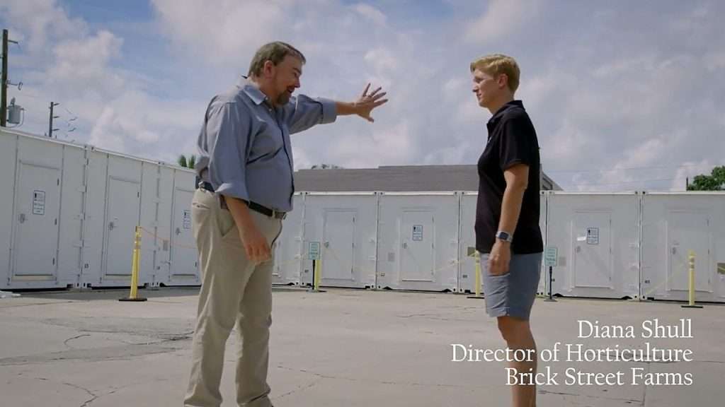 Chip and Diana from Brick Street Farms in city container farm lot.