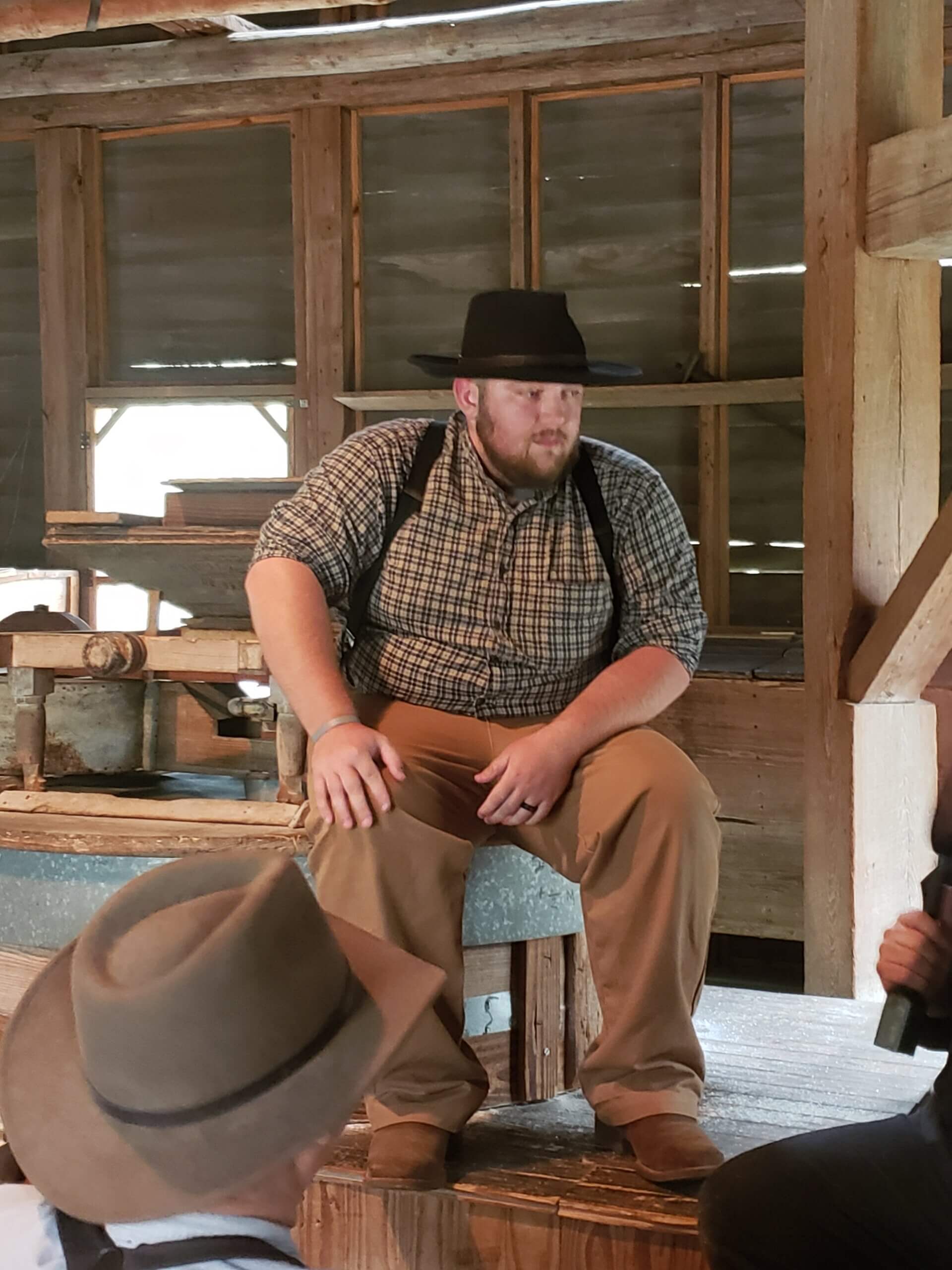 Sam Roy sitting in Davis Grist Mill