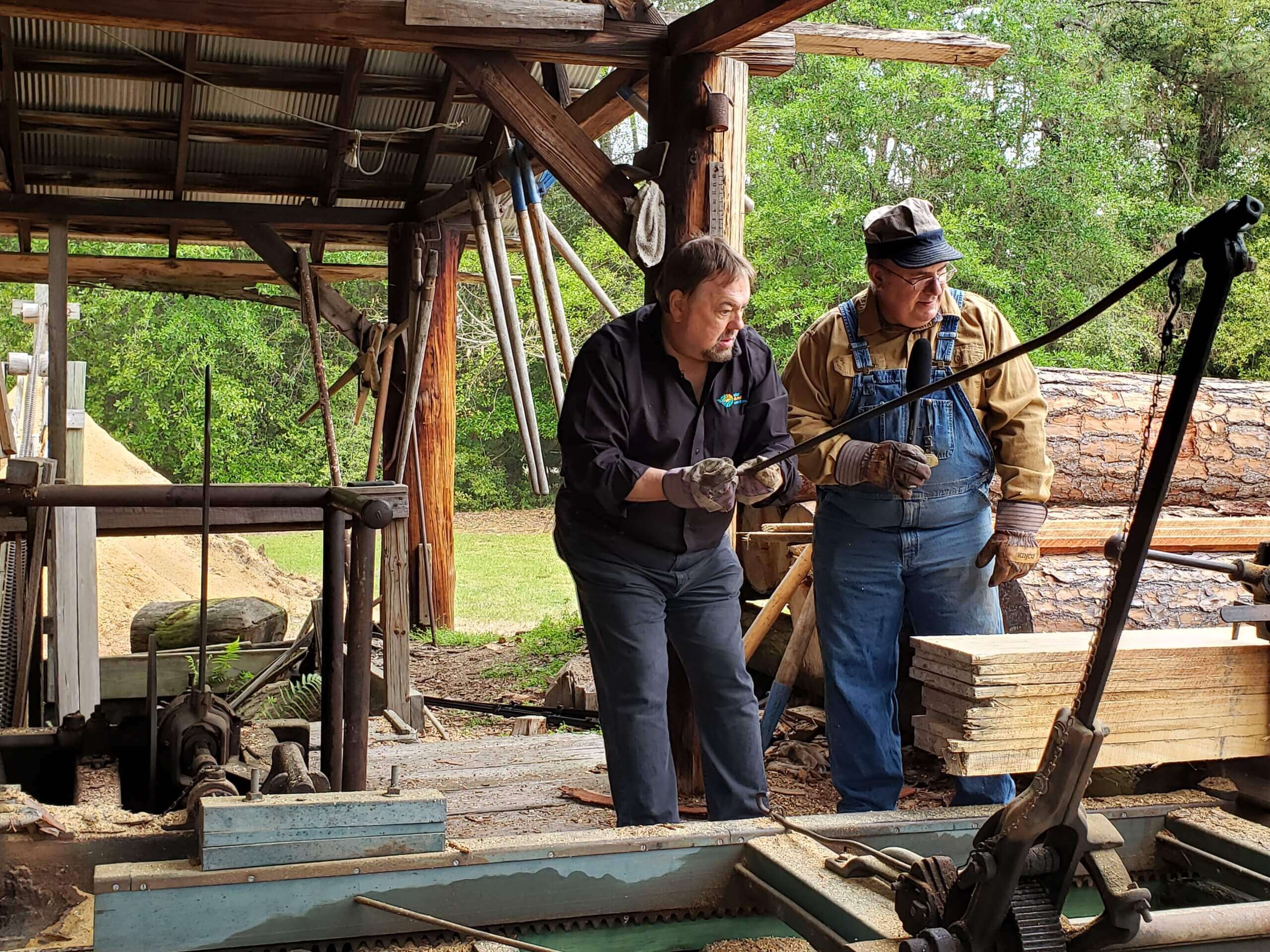 Chip and Keith Roucker of the museum working in the sawmill. 