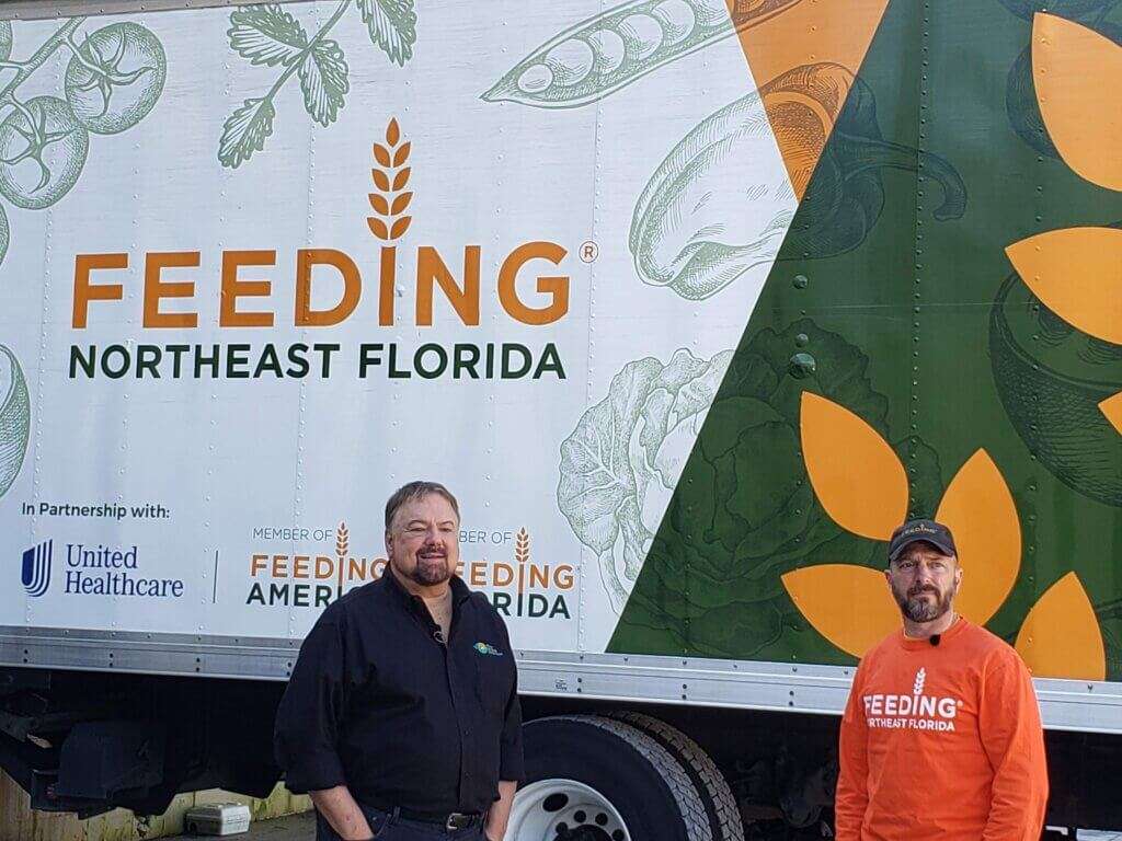 Host Chip Carter and Feeding America employee Eli Darkatsh.