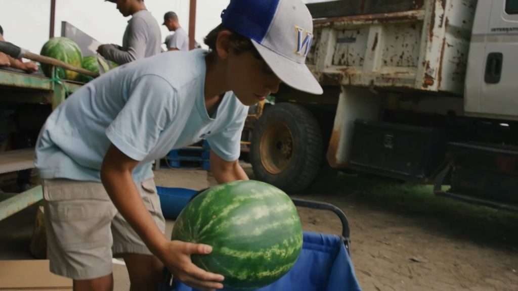 Cotton Gibbs carrying a watermelon