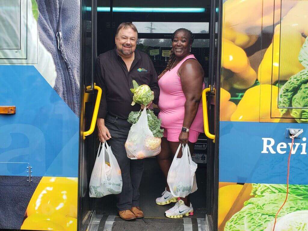 Chip and Ripe Revival shopper Christy at entrance of Ripe Revival mobile market. 