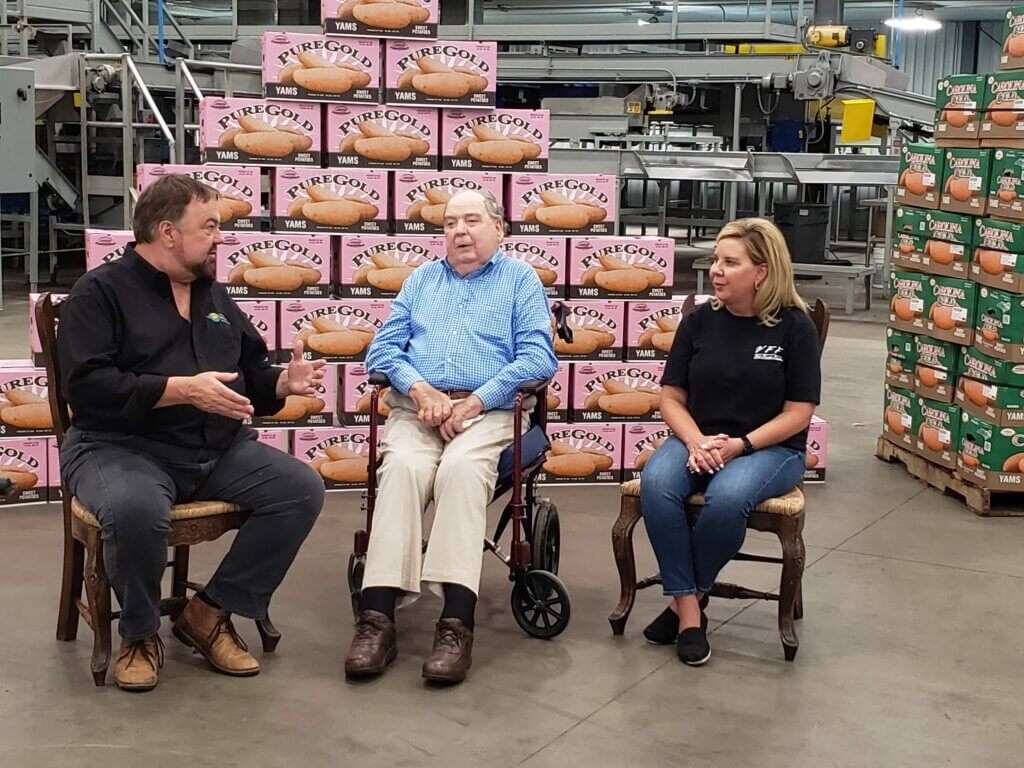 Chip Carter sitting with Jerome and Charlotte Vick of Vick Family Farms