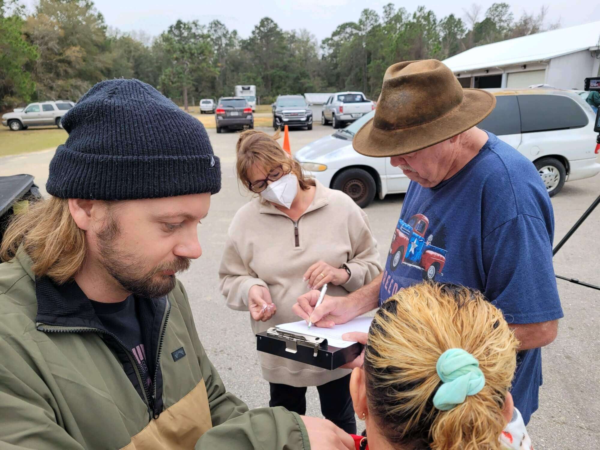 Man signs waiver at food distribution center. 