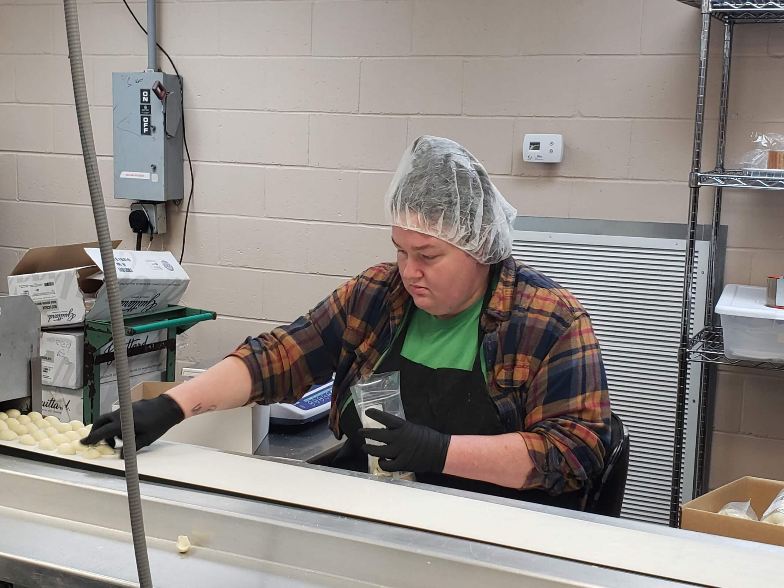 Stuckey's employee preps white-chocolate covered pecans.