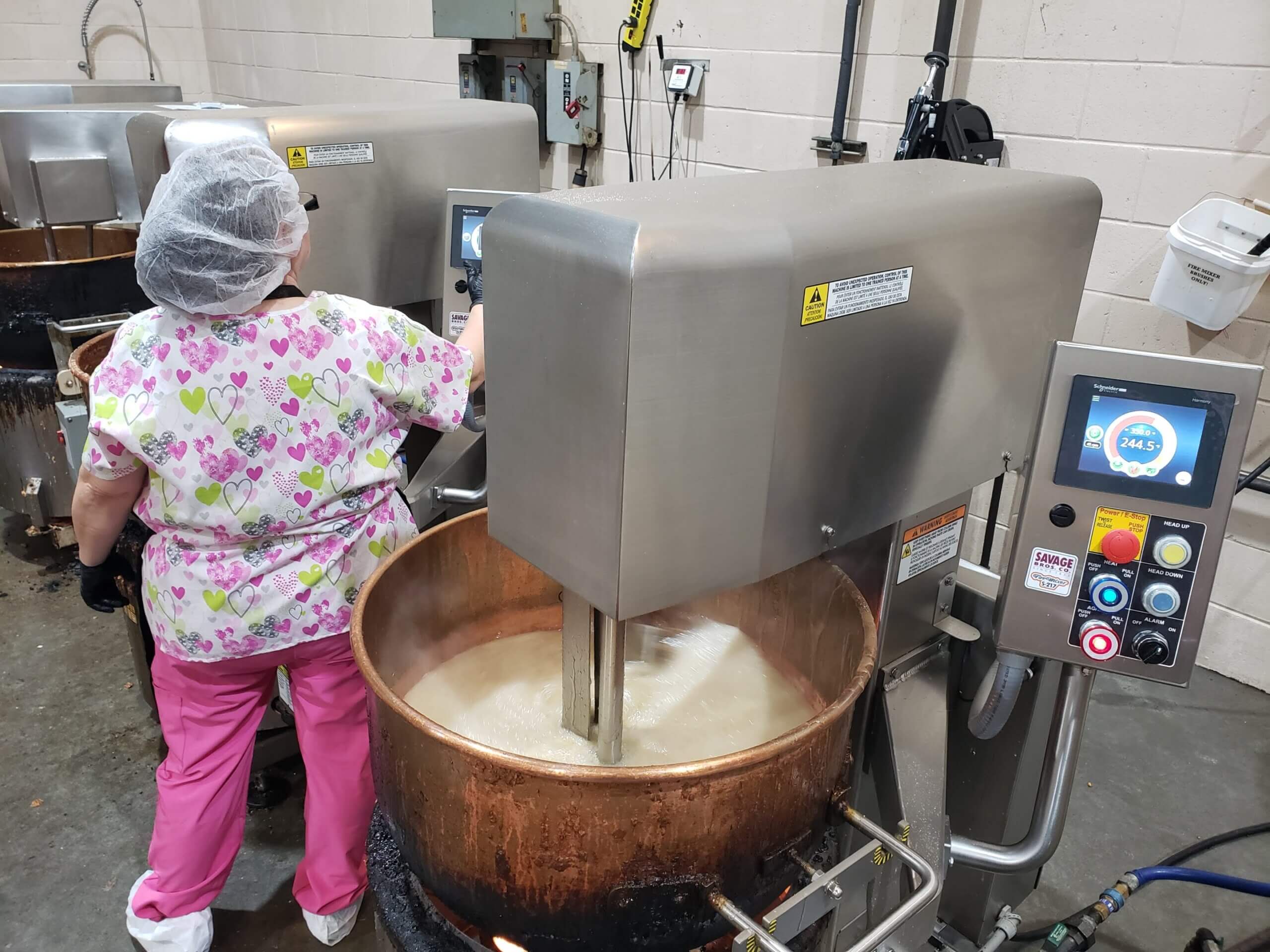 Stuckey's employee running giant copper kettle mixers. 