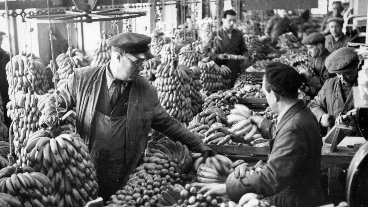 Vintage image: People shopping at a banana market.