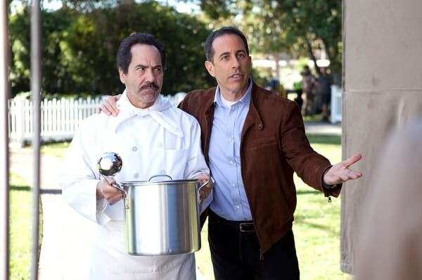 Larry Thomas holding a pot of soup next to Jerry Seinfeld