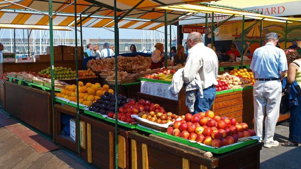 People browsing a farmers market.