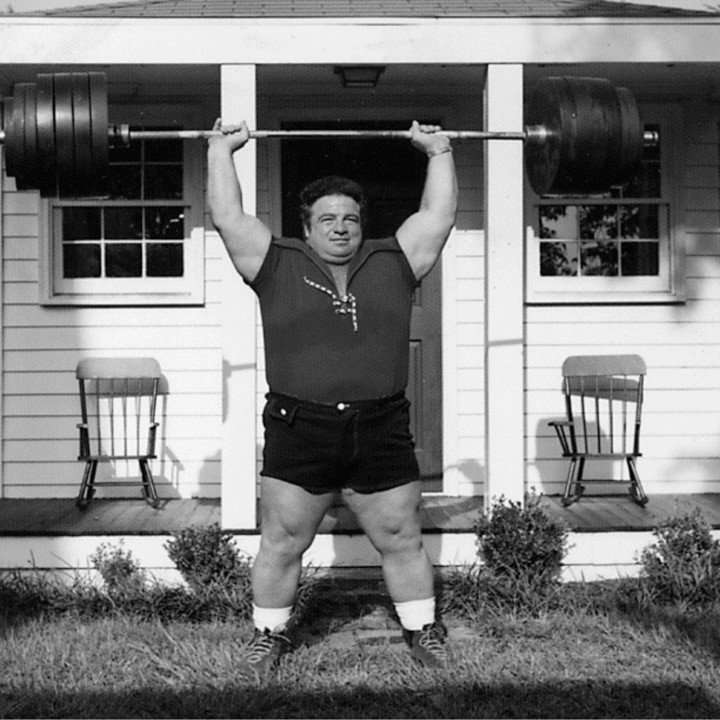 Powerlifter Paul Anderson lifting weights.