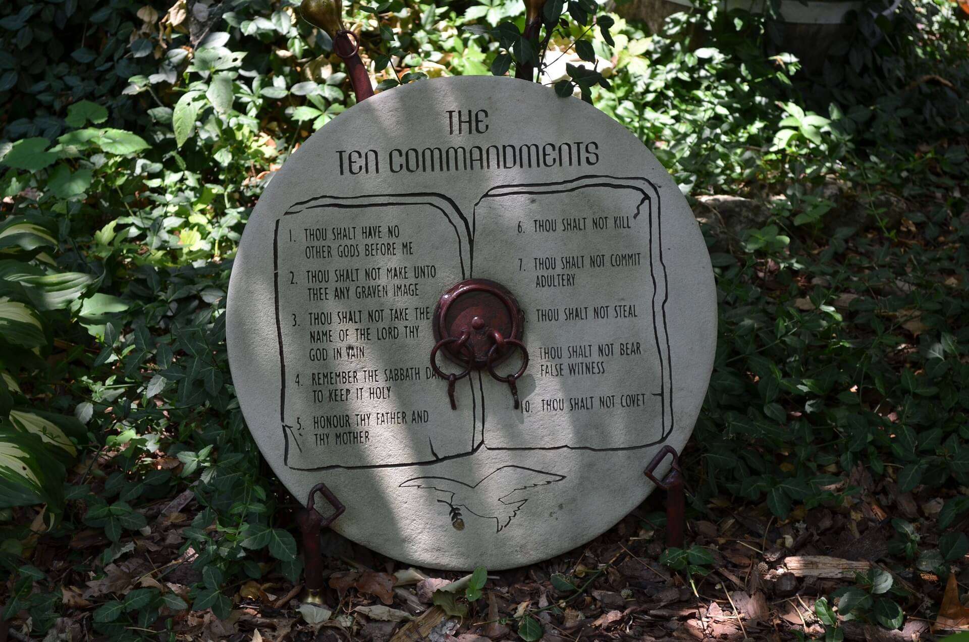 The Ten Commandments written on a circle piece of wood. 