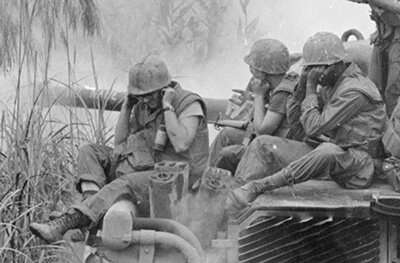 Soldiers in South Vietnam firing artillery. 