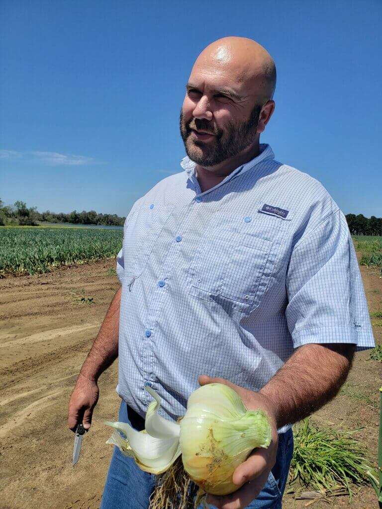 Aries Haygood holding a Vidalia onion.