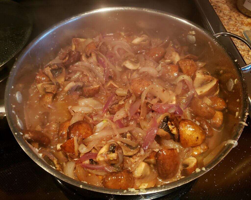 Simmering pot of mushrooms and Vidalia onions. 