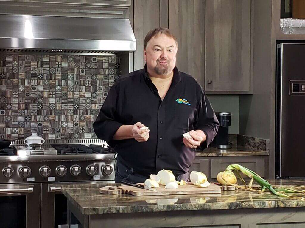 Host Chip Carter eating an onion.