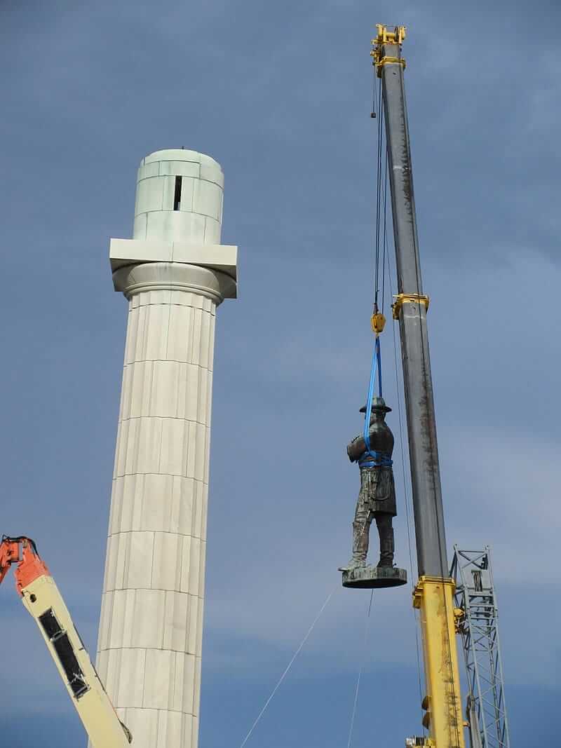 A statue of Robert E. Lee being taken down by a crane in New Orleans.
