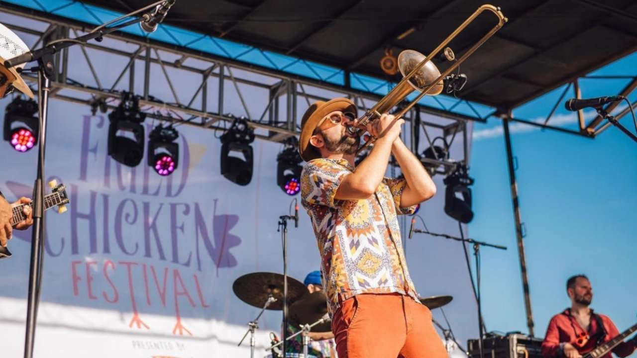 Trombone player on stage performing at the National Fried Chicken Festival.
