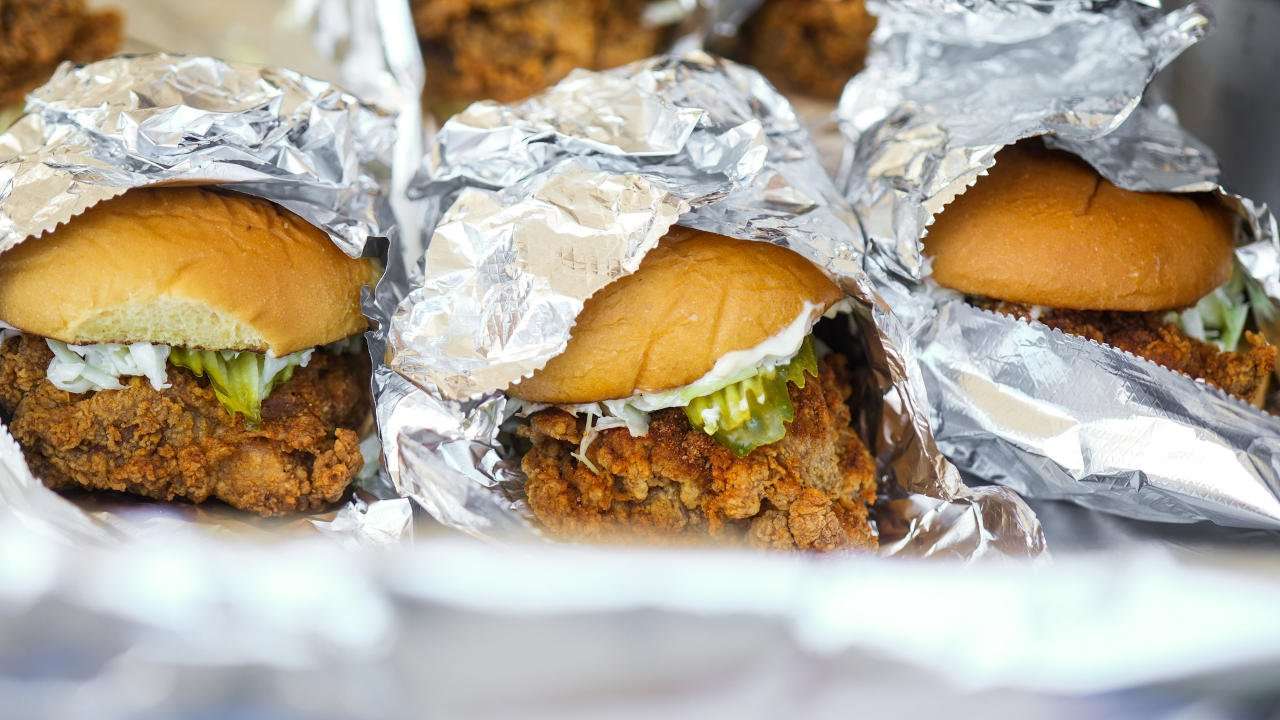 Fried chicken sandwiches topped with coleslaw. 