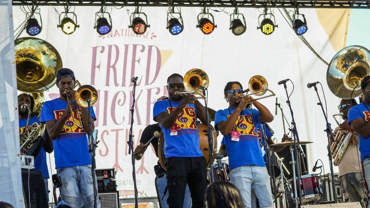 Trombone trio playing on stage. 