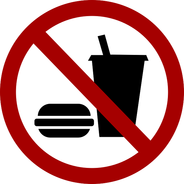 Burger and soft drink under prohibited symbol overlay. 