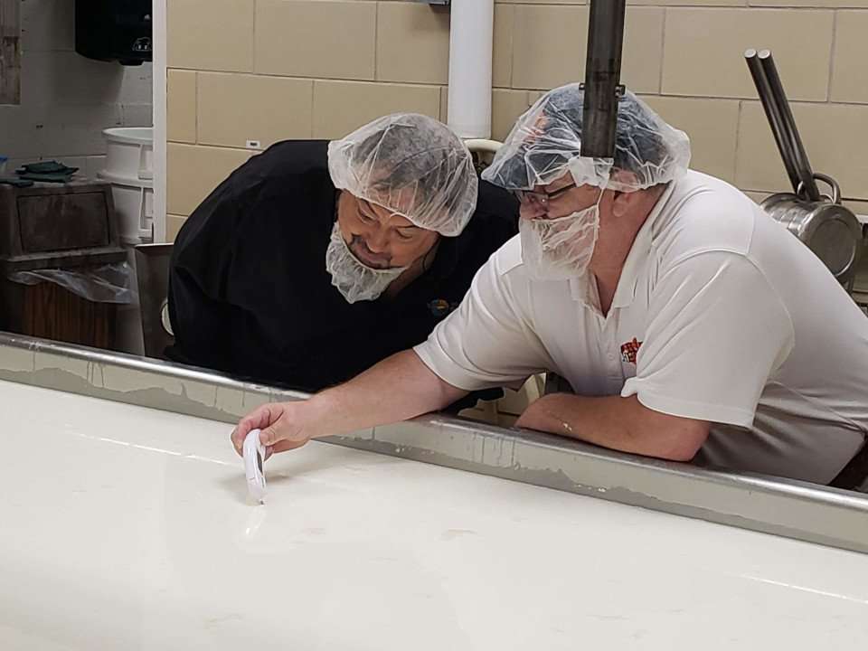 Clemson University Chip and Anthony Pounders monitoring milk temperature.