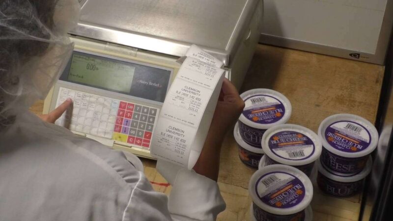 Clemson University student employee making Clemson Blue Cheese labels.