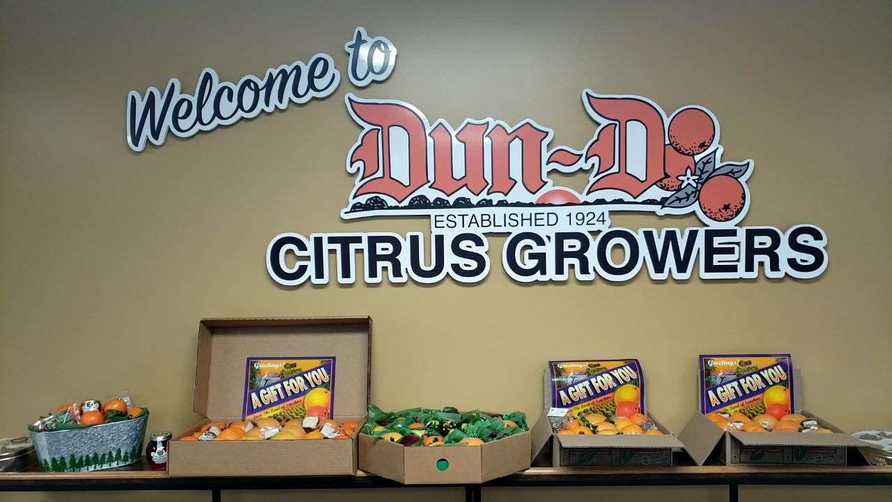 Dundee-Groves welcome sign with product displays.