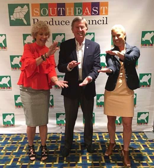 (L-R) Faye Westfall, Coach Steve Spurrier, and Raina Nelson making the "Gator" motion with their arms.