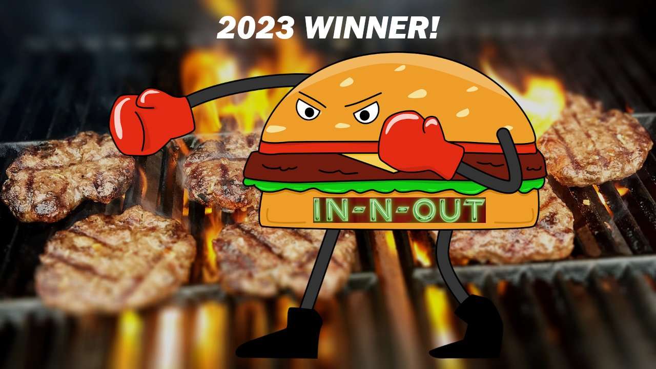 Burgers on a grill with a cartoon boxing In-N-Out hamburger throwing a punch.