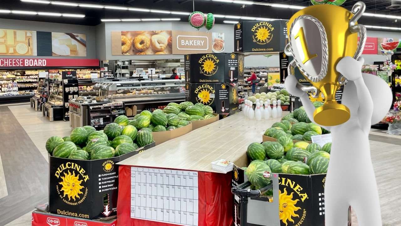 National Watermelon Promotions Board 2023 retail contest winning display, from Heritage Co-Op in Brandon, Maritoba, Canada with overlay of a cartoon person holding a championship cup.