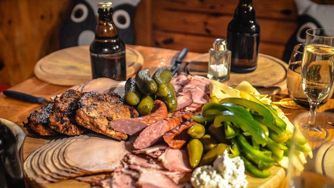 Charcuterie board with assorted foods.