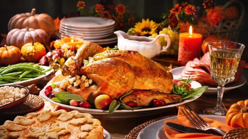 Thanksgiving dinner spread on dining room table.