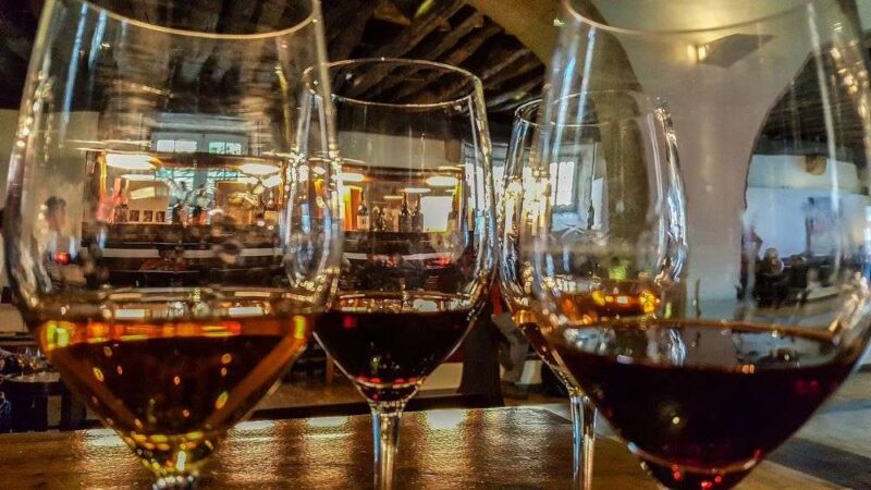 Closeup image of glasses of red and white wine in a restaurant.