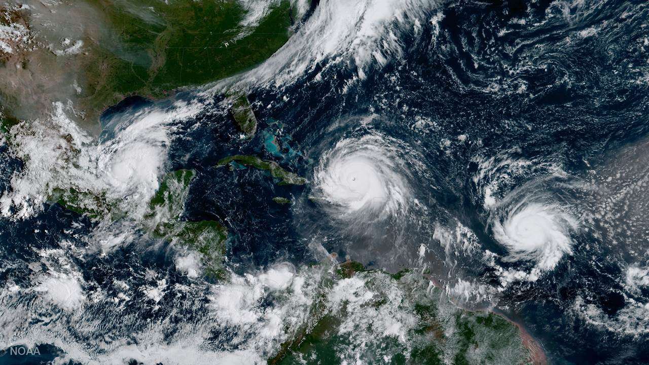Aerial view of two hurricanse in the Atlantic, one creeping closer to Florida.