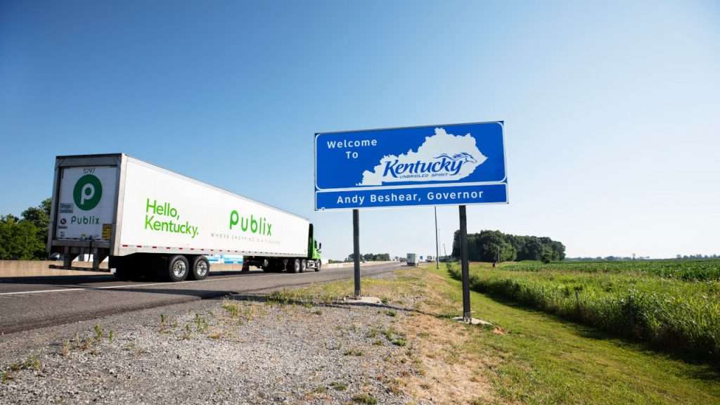 Publix truck on the highway driving past 'Welcome To Kentucky" road sound!