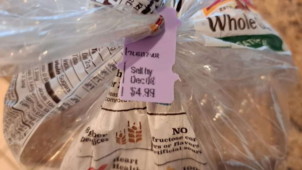 Close up of expiration date on clip of a bread bag.