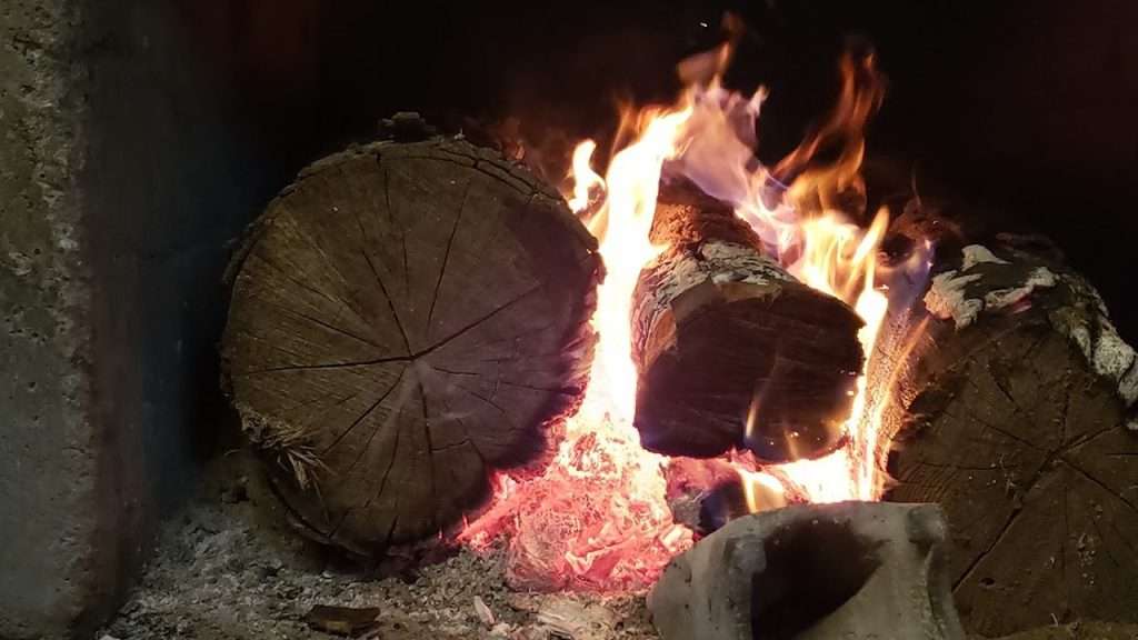 Logs burning in a fire.