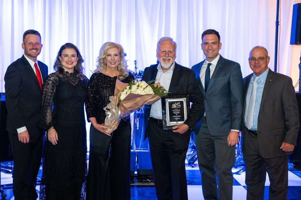 On stage at Florida Strawberry Growers Association Hall of Fame 2023 Event, Gary Wishnatzki inducted. Group Photo (L-R) Jake Rayburn, Candace Harrell, Therese Wishnatzki, Gary Wishnatzki, Nick Wishnatzki, Kenneth Parker