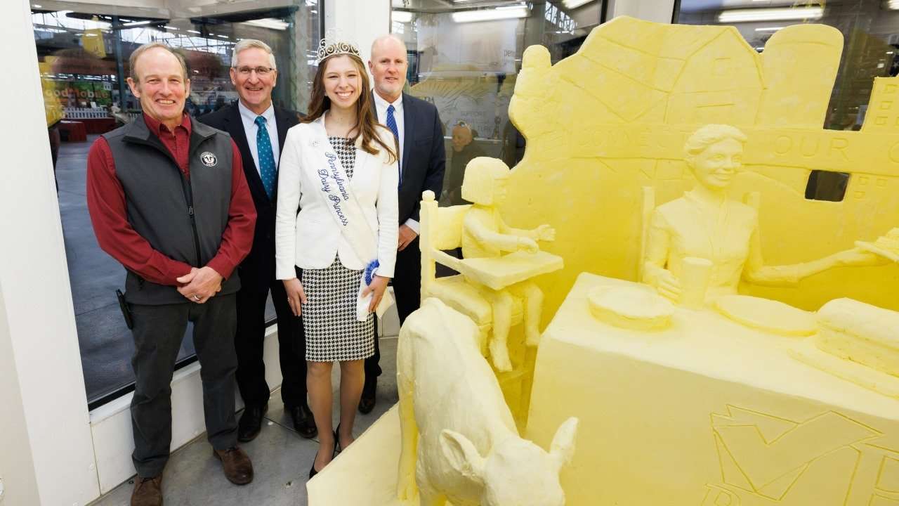 Left to right: Chester County Dairy Farmer Walt Moore, Agriculture Secretary Russell Redding, Pennsylvania Dairy Princess Alexis Butler and ADANE CEO John Chrisman standing with the 33rd butter sculpture.