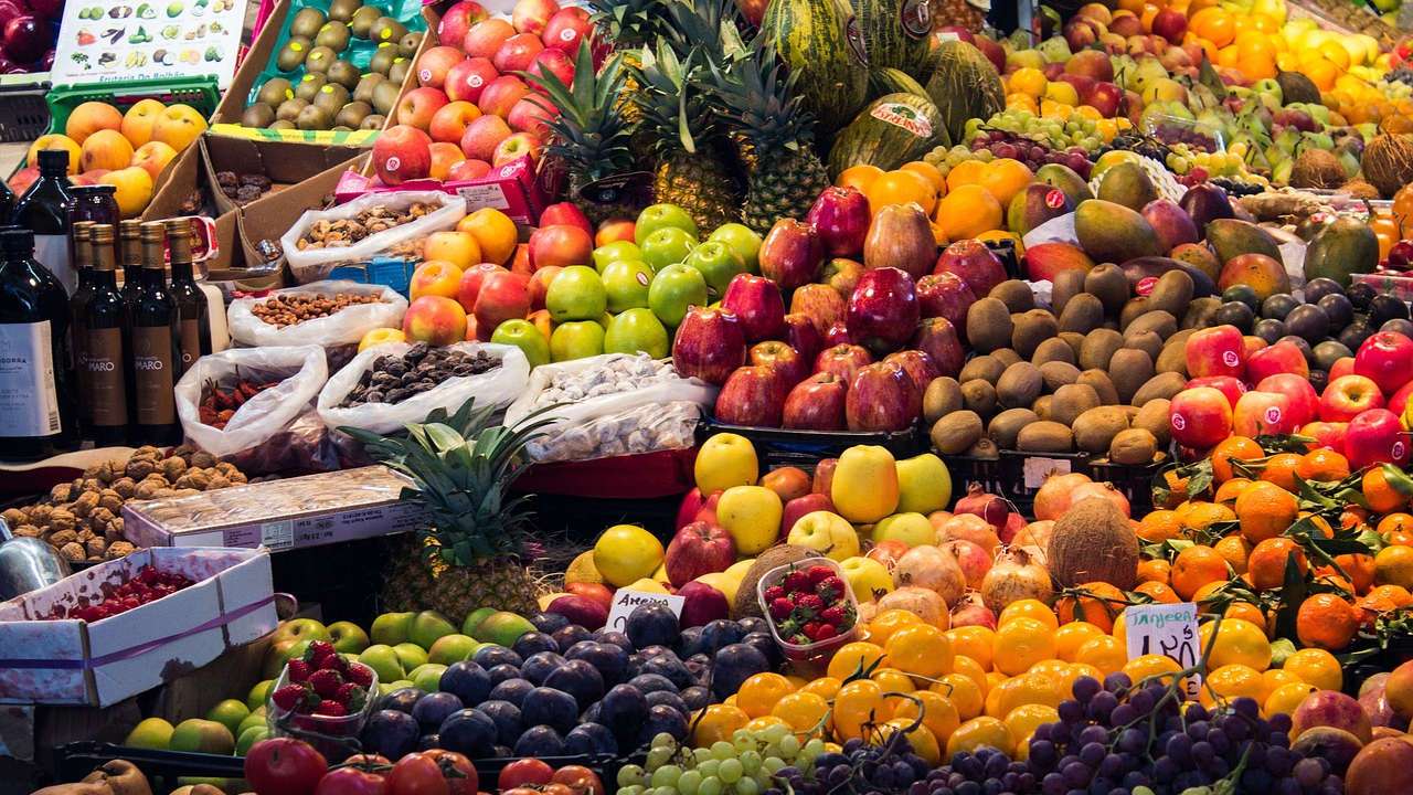 Assorted fruits, vegetables, nuts, olive oils and grains in Mediterranean market.