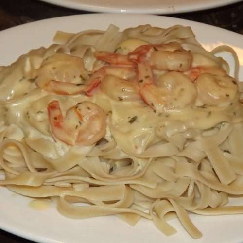 Bowl of pasta with shrimp in a cream sauce.