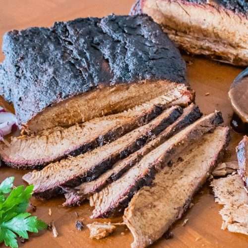 Texas Style Smoked Brisket with onions and BBQ sauce.