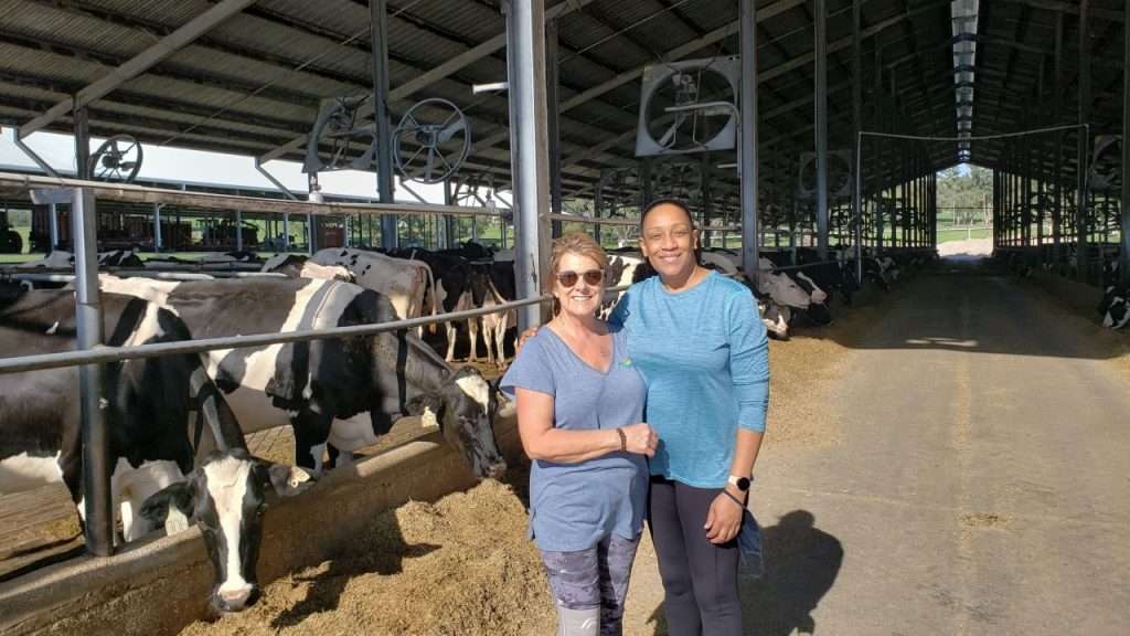 Where The Food Comes From field producer Donna Sanders and guest Mary Days on set in the cow barn at M&B Dairy.