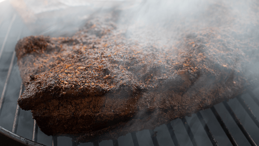 Brisket cooking on the grill. 