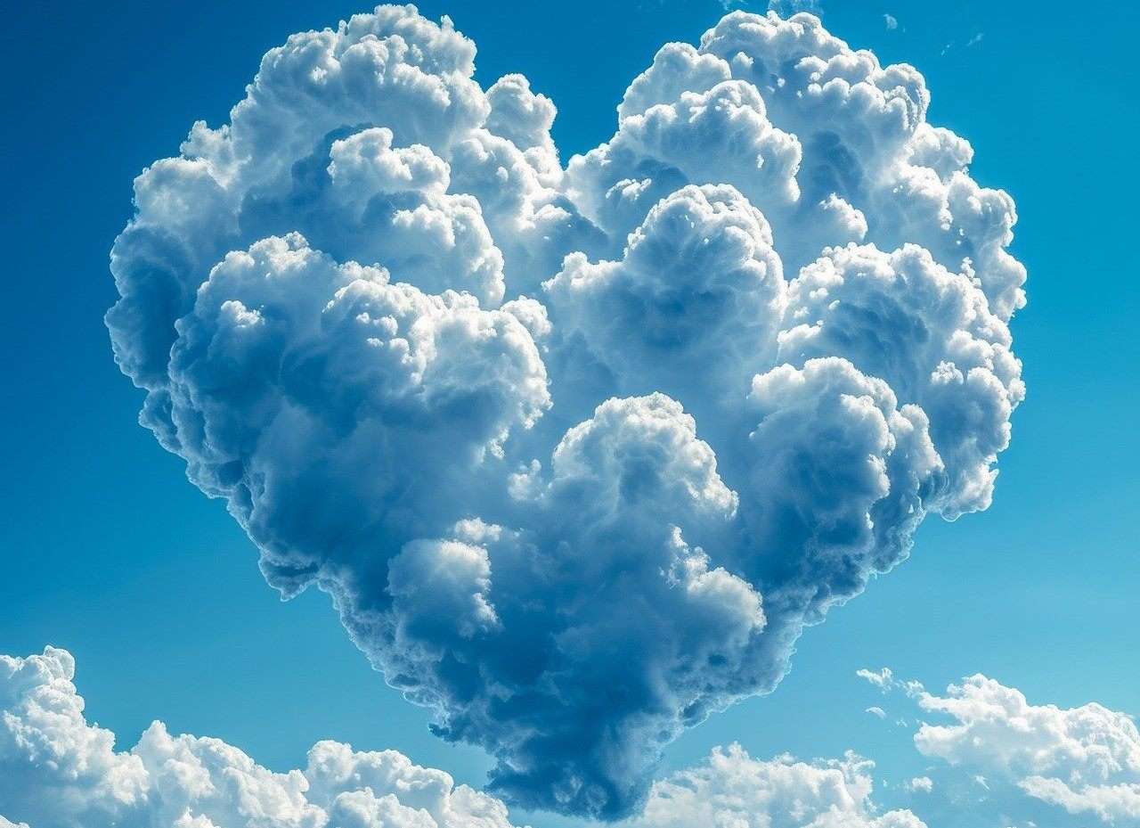 Heartshaped bunch of clouds in a blue sky.