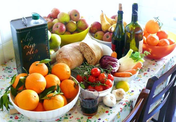 Assortment of foods included in the Mediterranean diet on a tablecloth.