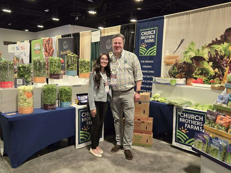 Angelic Meza and Ernst Van Eeghen of Church Brothers Farms in front of their display in the convention center.