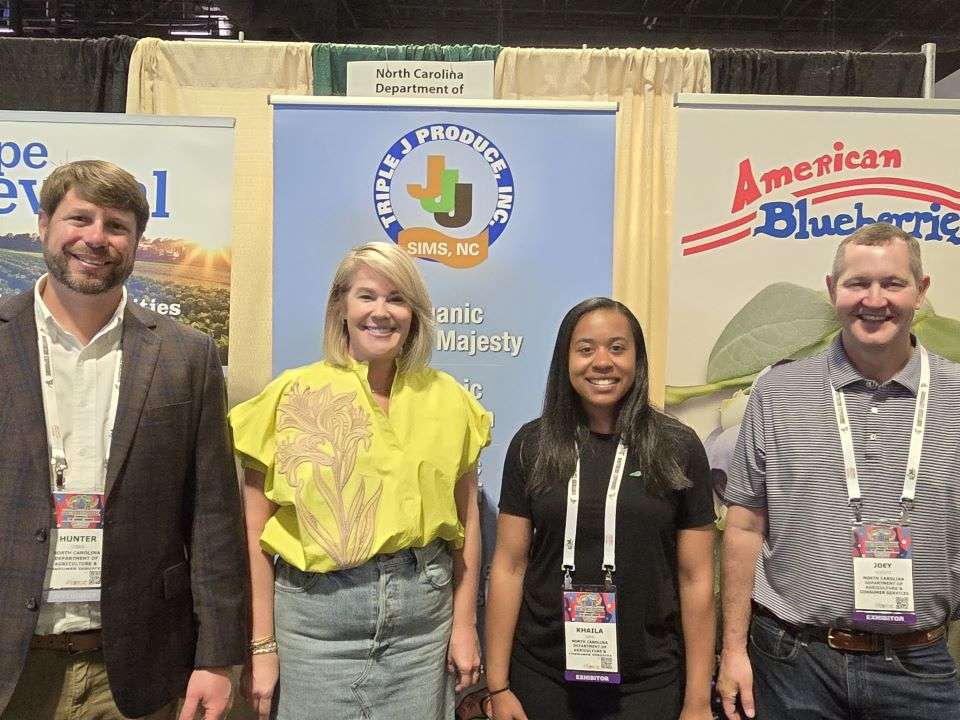 Hunter Gibbs, Kristi Hocutt, Khaila Daye and Joey Hocutt, North Carolina Department of Agriculture & Consumer Services in front of booth.