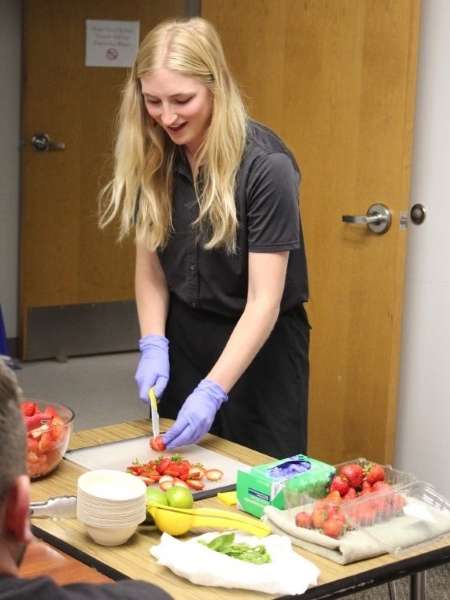 Madeleine French makes a strawberry-citrus salad in a Journey to Health class. Credit: Madeleine French