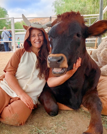 Ellie Laks posing with one of her trusted cows. 